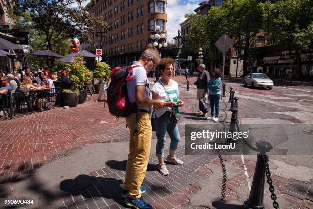 looking at travel guide book at gastown on canada day, vancouver,canada - sunny leon stock pictures, royalty-free photos & images