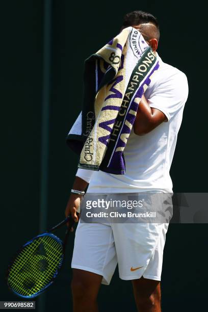 Nick Kyrgios of Australia towels down during his Men's Singles first round match against Denis Istomin of Uzbekistan on day two of the Wimbledon Lawn...