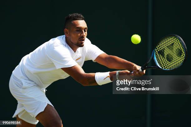 Nick Kyrgios of Australia plays a backhand during his Men's Singles first round match against Denis Istomin of Uzbekistan on day two of the Wimbledon...