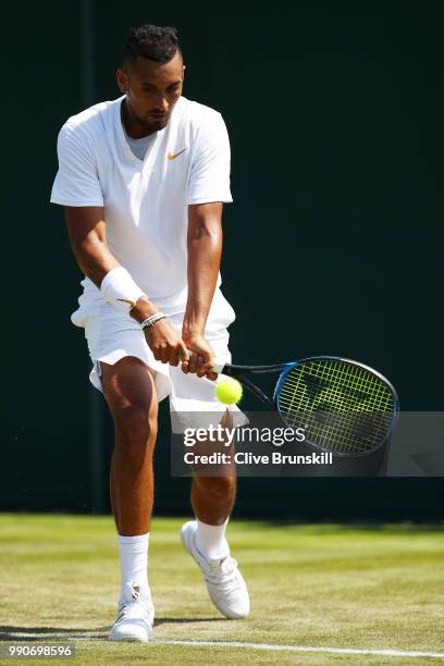 Nick Kyrgios of Australia plays a backhand during his Men's Singles first round match against Denis Istomin of Uzbekistan on day two of the Wimbledon...