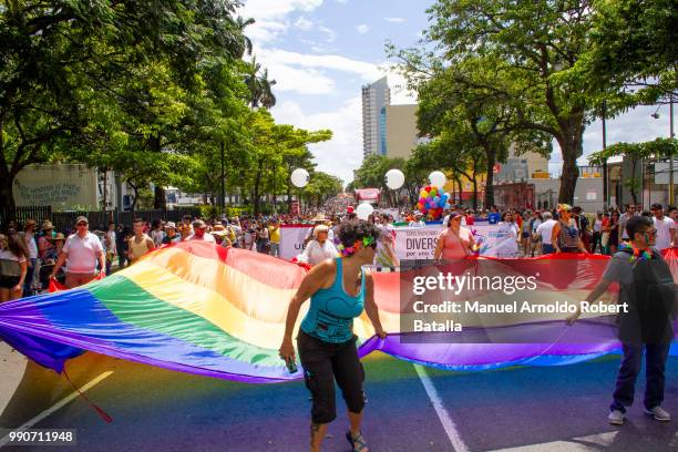 Participants display a LGBT flag during the San Jose's Gay Pride Parade on July 01, 2018 in San Jose, Costa Rica.