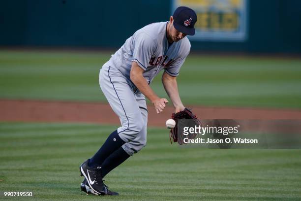 Trevor Bauer of the Cleveland Indians fields a ground ball against the Oakland Athletics during the first inning at the Oakland Coliseum on June 29,...