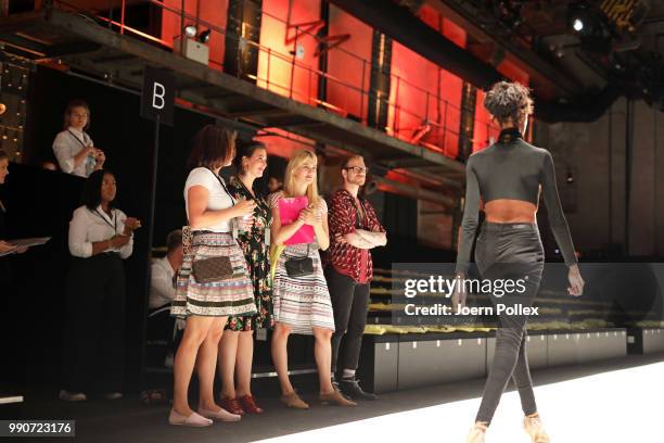 Designer Lena Hoschek stands with models near the runway ahead of her show during the Berlin Fashion Week Spring/Summer 2019 at ewerk on July 3, 2018...