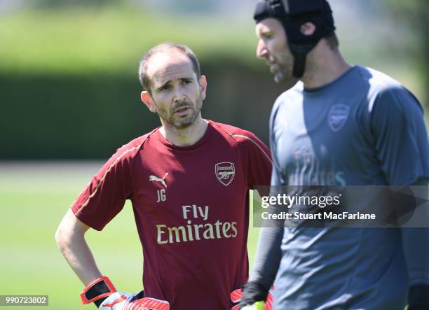 Arsenal goalkeeping coach Javi Garcia talks to Petr Cech of Arsenal during a training session at London Colney on July 3, 2018 in St Albans, England.