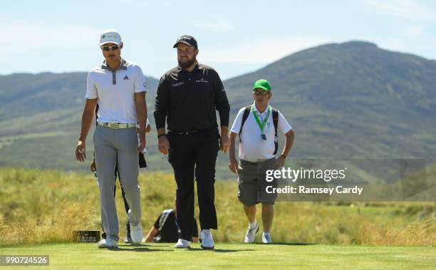 Donegal , Ireland - 3 July 2018; Shane Lowry of Ireland in conversation with Li Haotong of China during a practice round ahead of the Dubai Duty Free...