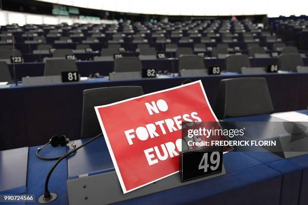 Sign reading 'No fortress Europe' is pictured prior to a debate on the outcome of the 28-29 June European Union summit during a plenary session at...