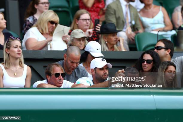 Xisca Perello , partner of Rafael Nadal of Spain, wears sunglasses as she watches from the stands with members of Nadal's coaching team during the...
