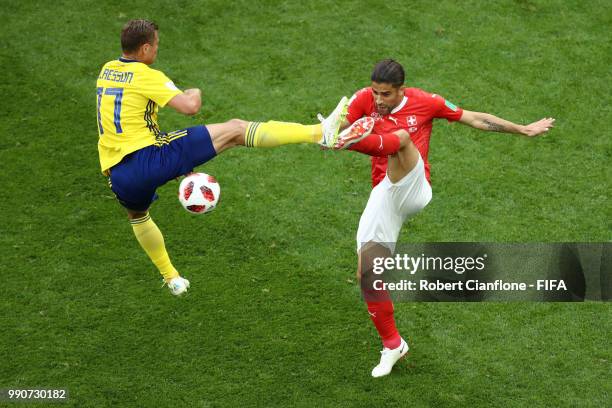 Viktor Claesson of Sweden tackles Ricardo Rodriguez of Switzerland during the 2018 FIFA World Cup Russia Round of 16 match between Sweden and...