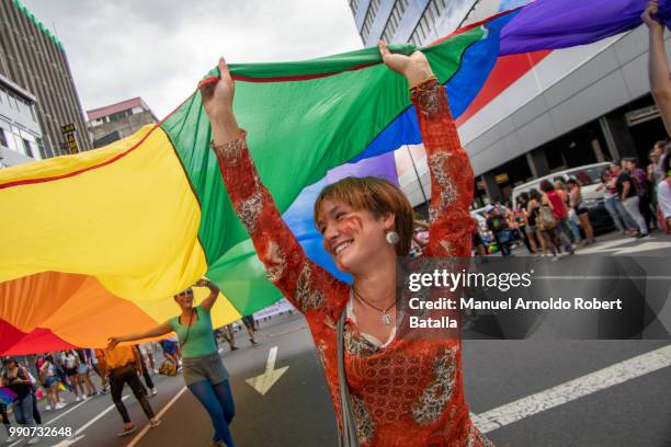 Participants display a LGBT flag during the San Jose's Gay Pride Parade at Paseo Colon Avenue on July 01, 2018 in San Jose, Costa Rica.