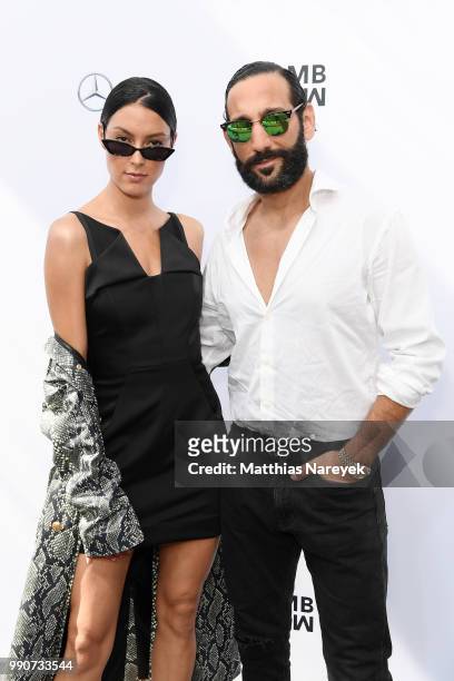 Rebecca Mir and husband Massimo Sinato attend the Lena Hoschek show during the Berlin Fashion Week Spring/Summer 2019 at ewerk on July 3, 2018 in...