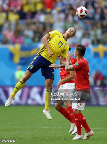 Viktor Claesson of Sweden wins a header from Ricardo Rodriguez of Switzerland and Steven Zuber of Switzerland during the 2018 FIFA World Cup Russia...