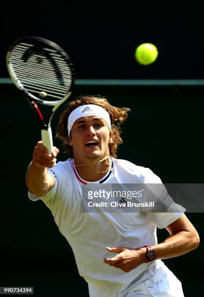Alexander Zverev of Germany returns against James Duckworth of Australia during their Men's Singles first round match on day two of the Wimbledon...