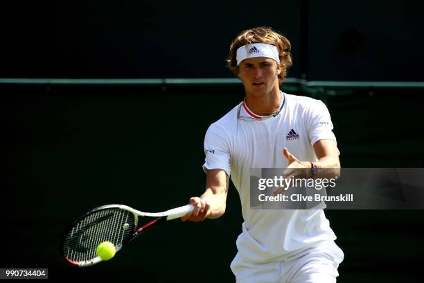 Alexander Zverev of Germany returns against James Duckworth of Australia during their Men's Singles first round match on day two of the Wimbledon...