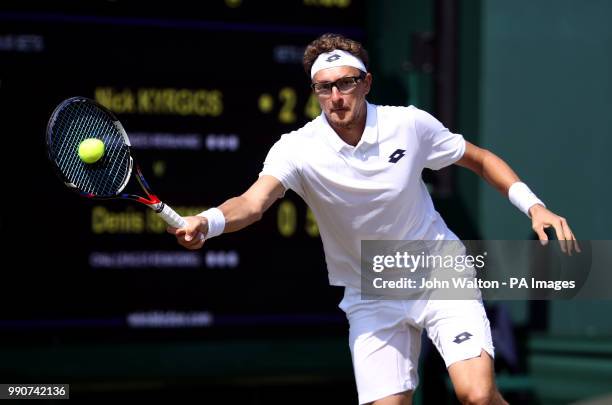 Denis Istomin in action on day two of the Wimbledon Championships at the All England Lawn Tennis and Croquet Club, Wimbledon.