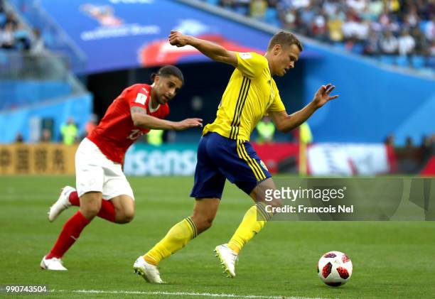 Viktor Claesson of Sweden is challenged by Ricardo Rodriguez of Switzerland during the 2018 FIFA World Cup Russia Round of 16 match between Sweden...