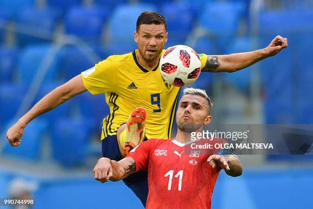 Sweden's forward Marcus Berg fights for the ball with Switzerland's midfielder Valon Behrami during the Russia 2018 World Cup round of 16 football...
