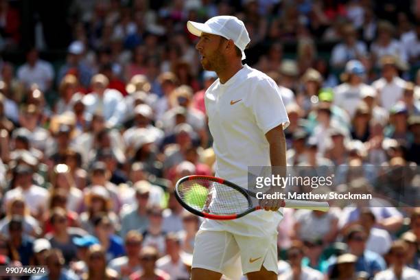 Dudi Sela of Isreal reacts during his Men's Singles first round match against Rafael Nadal of Spain on day two of the Wimbledon Lawn Tennis...