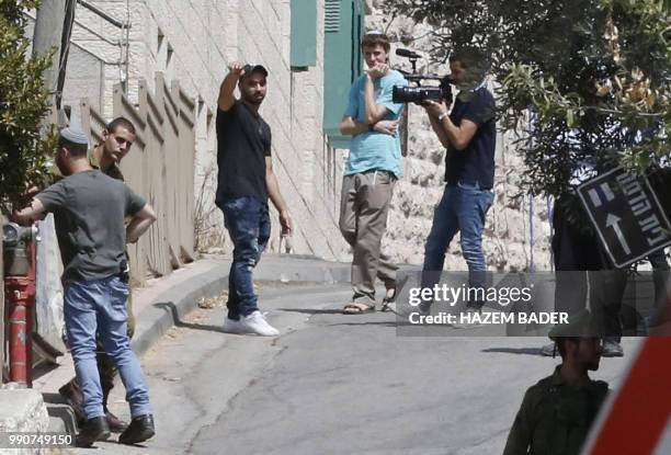 Former Israeli soldier Elor Azaria gestures as he visits friends in the settlement of Tal Rumeida in the occupied West Bank city of Hebron on July 3,...