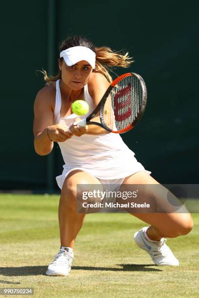 Gabriella Taylor of Great Britain returns against Eugenie Bouchard of Canada during her Ladies' Singles first round match against on day two of the...