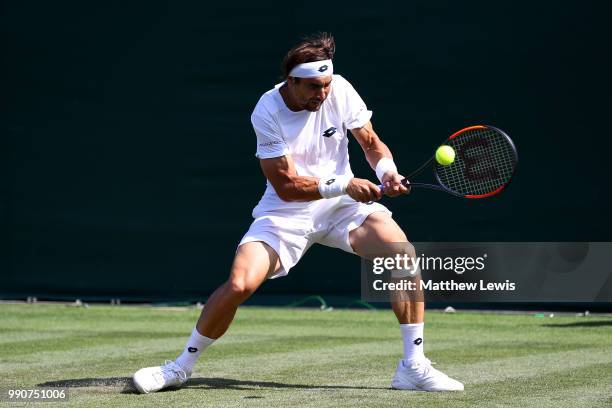 David Ferrer of Spain returns against Karen Khachanov of Russia during their Men's Singles first round match on day two of the Wimbledon Lawn Tennis...