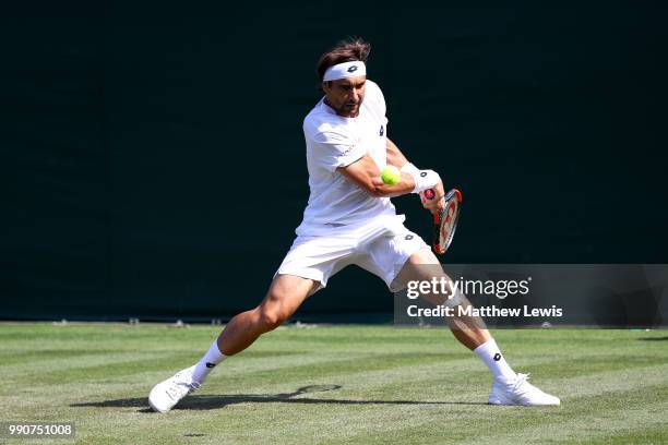 David Ferrer of Spain returns against Karen Khachanov of Russia during their Men's Singles first round match on day two of the Wimbledon Lawn Tennis...