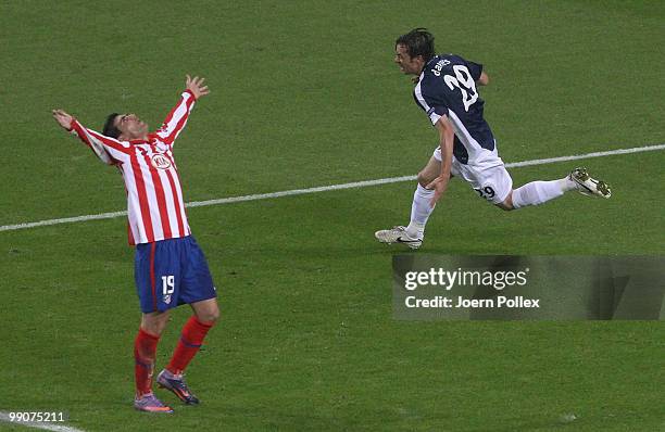 Simon Davies of Fulham celebrates after scoring his team's first goal while Jose Antonio Reyes of Atletico Madrid reacts during the UEFA Europa...