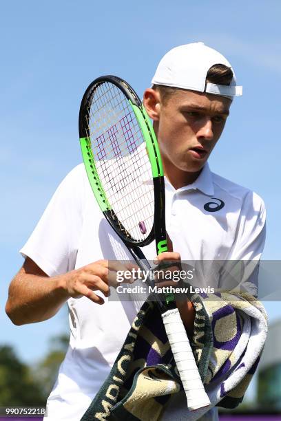 Alex De Minaur of Australia with a towel during his Men's Singles first round match against Marco Cecchinato of Italy on day two of the Wimbledon...