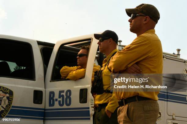 Arvada Fire Department wildland firefighters from left to right Justin Cotsamire, Patrick Jungels, and Jeremy Gaccetta, on Brush 58, watch for hot...