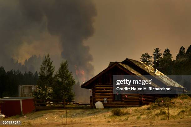 Flare up is seen behind a home along Highway 285 on the Weston Pass Fire on July 2, 2018 near Fairplay, Colorado. The fire, burning about 20 miles...