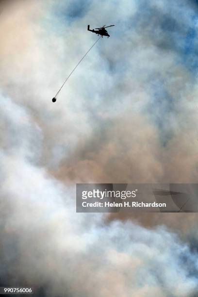 Helicopter returns for water after making a water drop on the Weston Pass Fire on July 2, 2018 near Fairplay, Colorado. The fire, burning about 20...