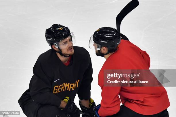 Moritz Mueller and Felix Schuetz talk on the ice during a training session of the German team at Kwandong-Hockey-Centre in Gangneung, South Korea, 24...