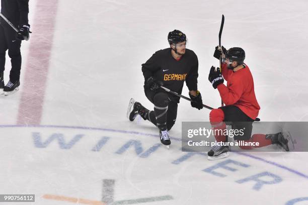 Moritz Mueller and Felix Schuetz talk on the ice during a training session of the German team at Kwandong-Hockey-Centre in Gangneung, South Korea, 24...