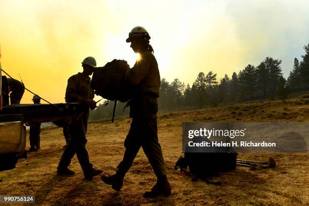 Members of the Craig Hotshots pack their gear into their crew cabs after a long day of fighting the Weston Pass Fire on July 2, 2018 near FairPlay,...