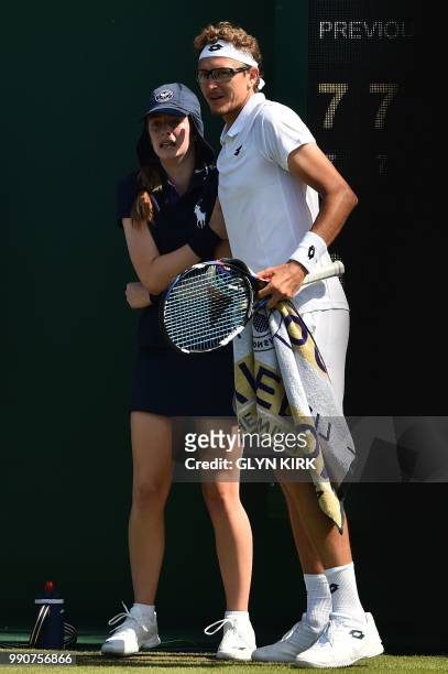 Uzbekistan's Denis Istomin consoles a ballgirl after a she was hit by a ball served by his opponenet, Australia's Nick Kyrgios, during their men's...