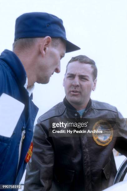 Driver Pat O'Connor talks to a crew member before the start of the USAC 100 mile championship race on March 30, 1958 in Trenton, New Jersey.