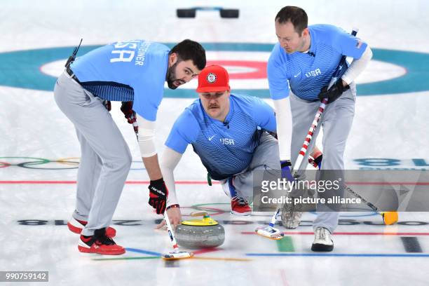 S John Landsteiner , John Shuster and Tyler George in action at the men's curling finals between the US and Sweden at the Curling Centre in...
