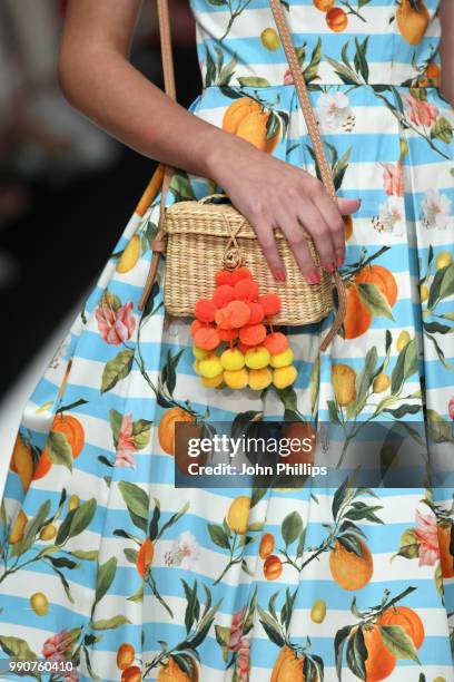 Model, bag detail, walks the runway at the Lena Hoschek show during the Berlin Fashion Week Spring/Summer 2019 at ewerk on July 3, 2018 in Berlin,...