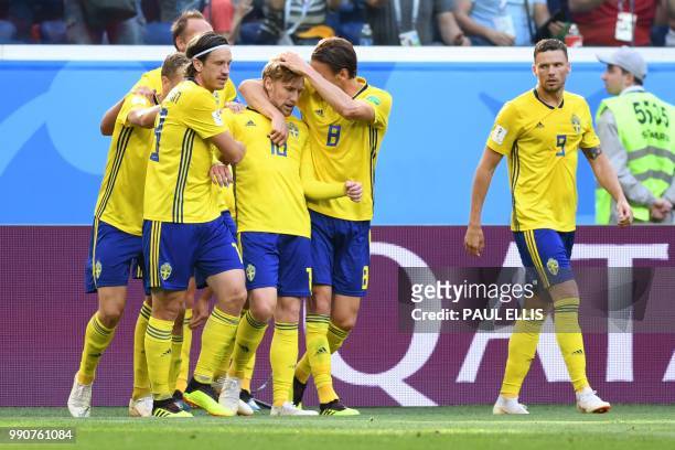 Sweden's midfielder Emil Forsberg celebrates with teammates after scoring the opener during the Russia 2018 World Cup round of 16 football match...