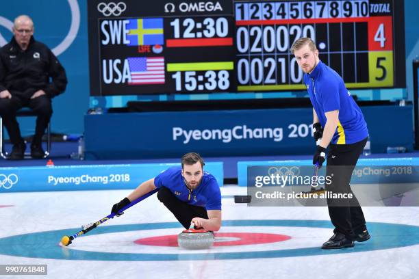 Sweden's Rasmus Wranaa and Oskar Eriksson in action at the men's curling finals between the US and Sweden at the Curling Centre in Gangneung, South...