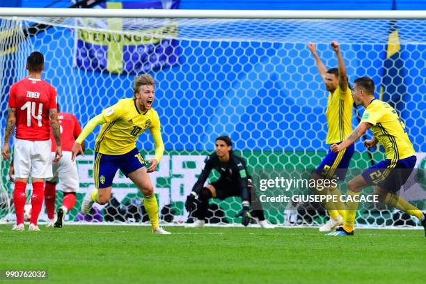 Sweden's midfielder Emil Forsberg celebrates scoring during the Russia 2018 World Cup round of 16 football match between Sweden and Switzerland at...