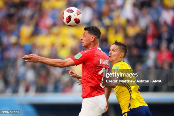 Blerim Dzemaili of Switzerland competes with Mikael Lustig of Sweden during the 2018 FIFA World Cup Russia Round of 16 match between Sweden and...