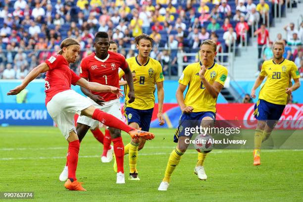 Michael Lang of Switzerland shoots past Ludwig Augustinsson of Sweden during the 2018 FIFA World Cup Russia Round of 16 match between Sweden and...