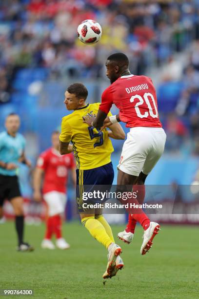 Johan Djourou of Switzerland wins a header over Marcus Berg of Sweden during the 2018 FIFA World Cup Russia Round of 16 match between Sweden and...