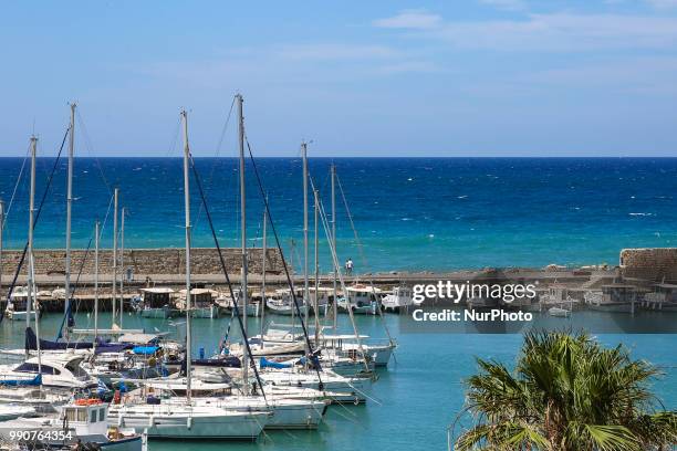 Little port in Heraklion city. Traditional fishing boats moored in the harbour with the Venetian Koules castle in the background. Heraklion, Crete...