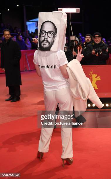 Person wears a bag on their head showing the face of director Kirill Serebrennikov and a t-shirt reading 'I have to stay home' at the award ceremony...