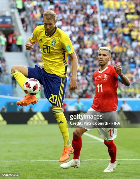 Ola Toivonen of Sweden is challenged by Valon Behrami of Switzerland during the 2018 FIFA World Cup Russia Round of 16 match between Sweden and...