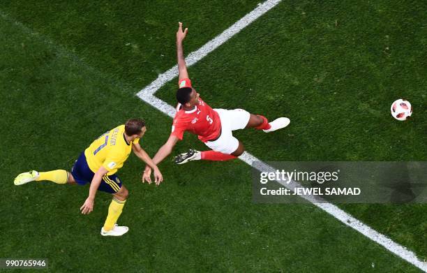 Sweden's midfielder Viktor Claesson vies with Switzerland's defender Manuel Akanji during the Russia 2018 World Cup round of 16 football match...