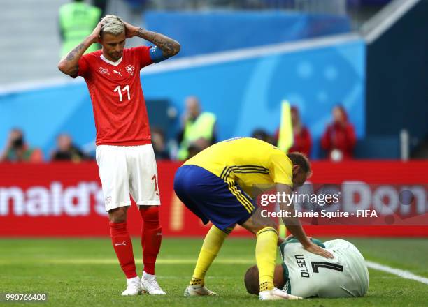 Andreas Granqvist of Sweden checks on Robin Olsen of Sweden who goes down during the 2018 FIFA World Cup Russia Round of 16 match between Sweden and...