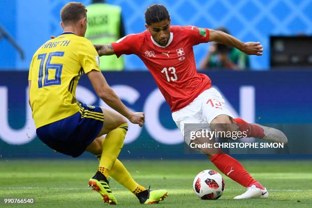 Switzerland's defender Ricardo Rodriguez challenges Sweden's defender Emil Krafth during the Russia 2018 World Cup round of 16 football match between...