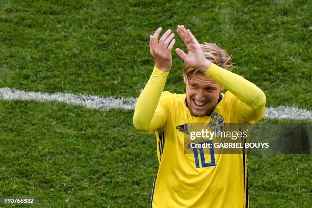 Sweden's midfielder Emil Forsberg greets fans as he leaves the pitch during the Russia 2018 World Cup round of 16 football match between Sweden and...